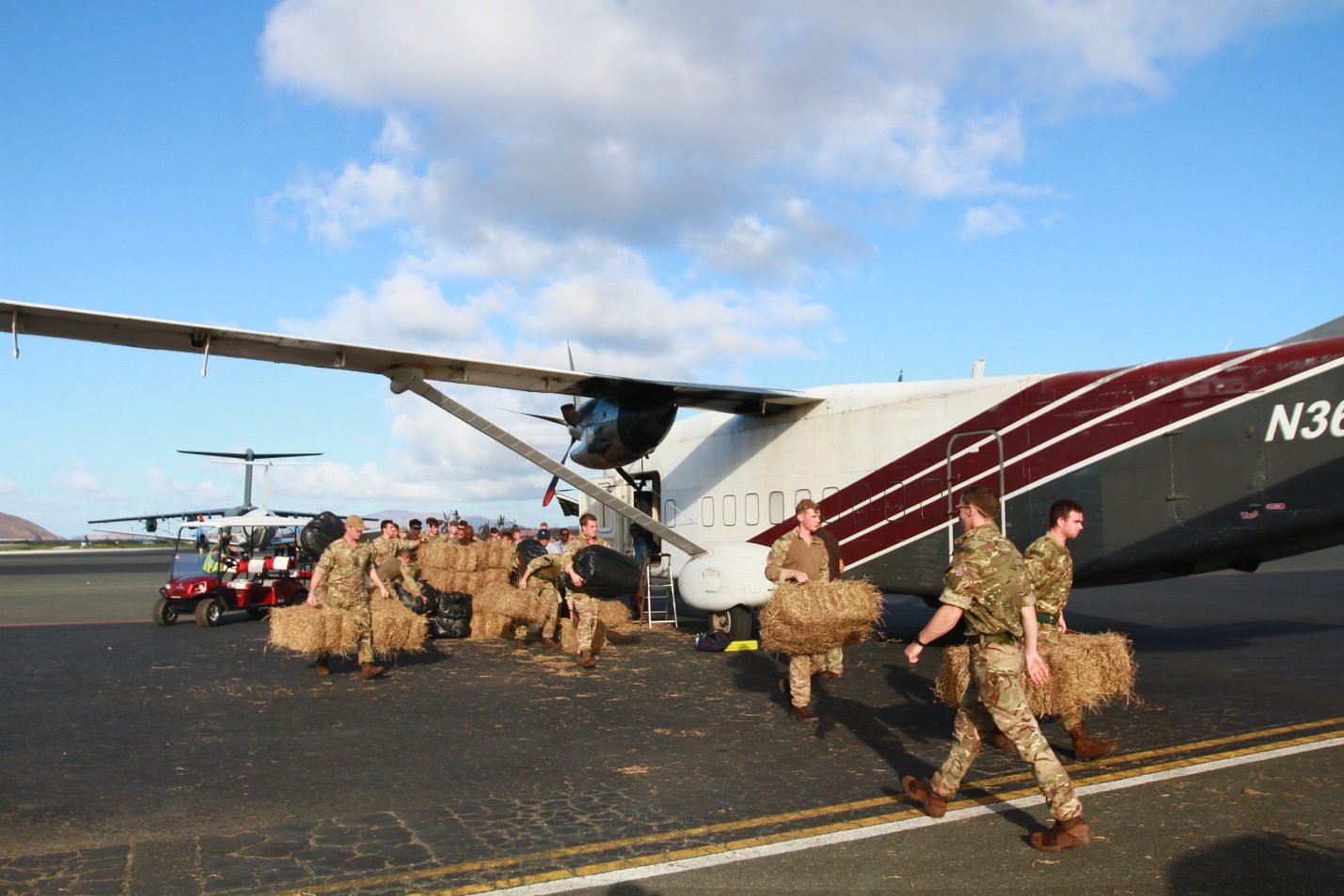 Marines unloading hay bales during H/3 Foundation and HSI rescue operation in the British Virgin Islands