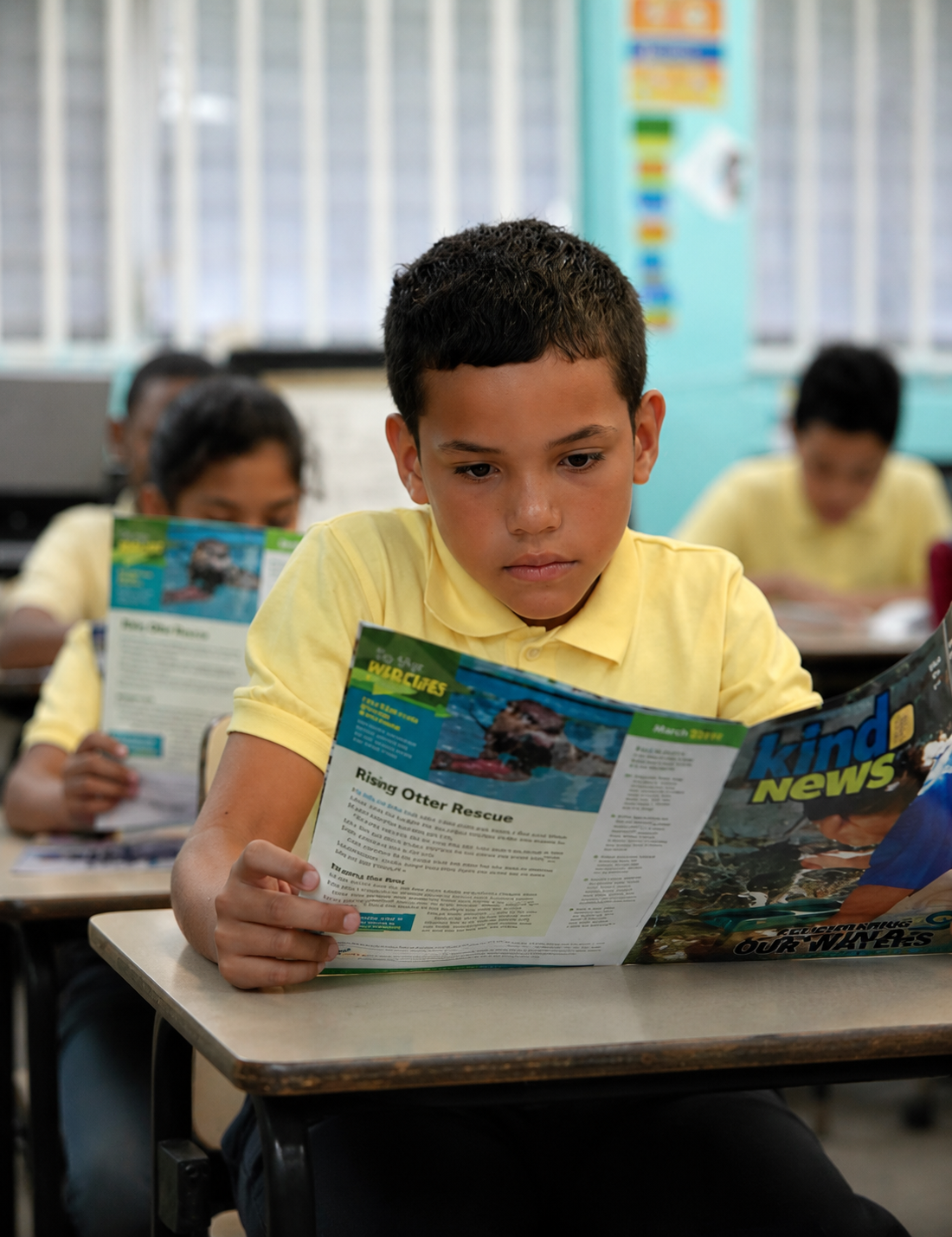 A Puerto Rican student reading Kind News magazine in class as part of the Humane Puerto Rico program
